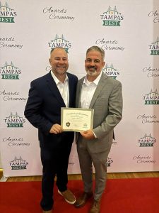 Big Wave Restoration owners holding their award at the Tampa’s Best ceremony