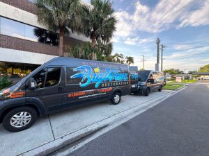 Big Wave Restoration service vans parked outside a commercial property