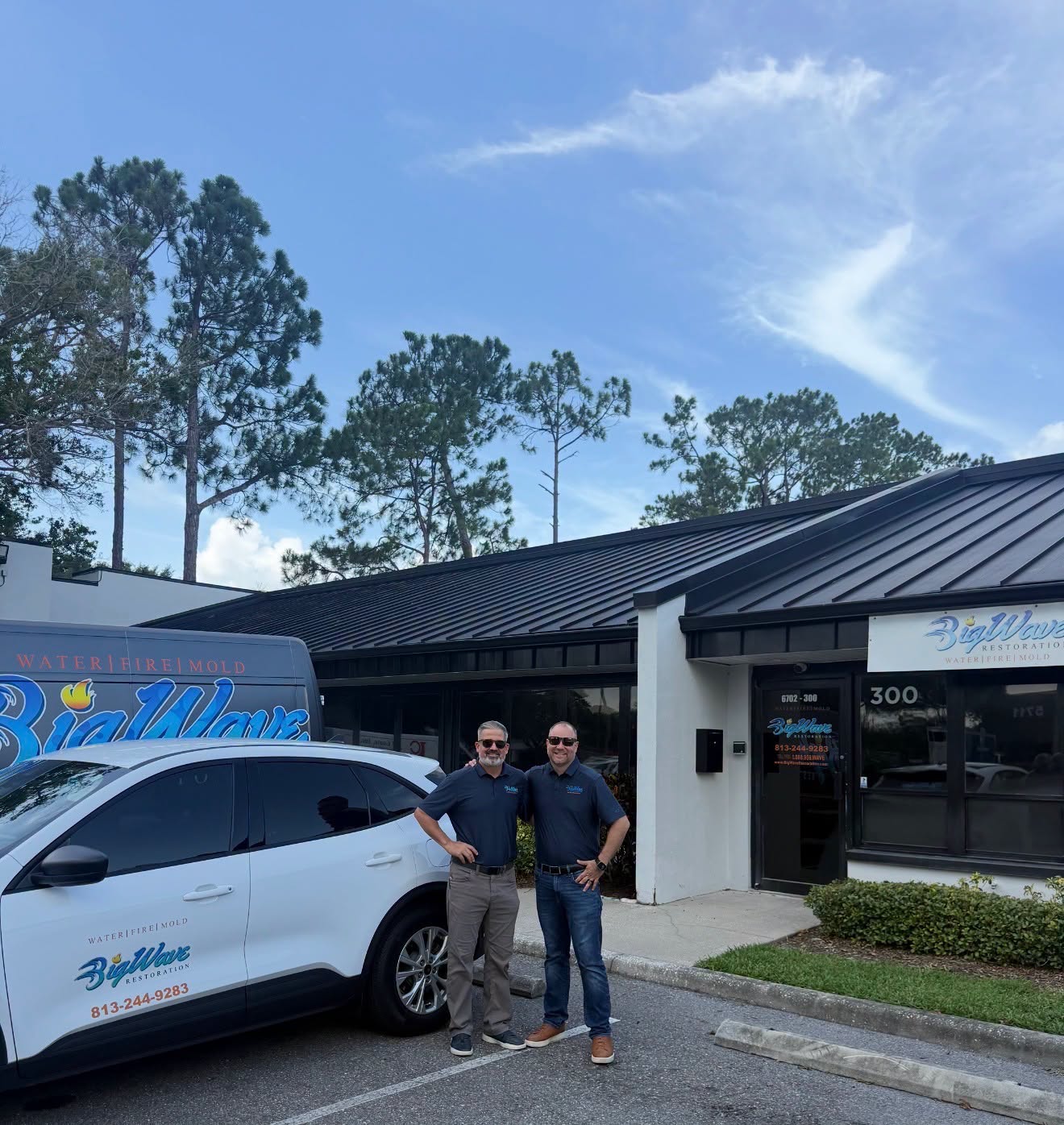 Big Wave Restoration owners outside their company office